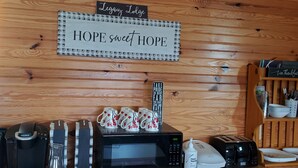 A kitchen area with a coffee maker, microwave, toaster, and a sign that reads "Legacy Lodge HOPE sweet HOPE". - A remote getaway ... Enjoy nature, have fun and embrace relaxation! (windsor)