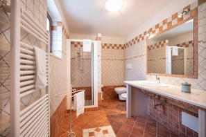 A bathroom with a shower, toilet, and sink.