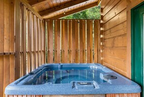 A wooden cabin with a hot tub.