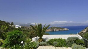 A coastal property with a view of the sea, a white building, and surrounding greenery. - Istron Collection Villas (Lasithi)