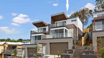 A modern residential complex with multiple two-story houses, a central staircase, and a well-maintained garden area.