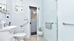 A modern bathroom with a glass shower enclosure, a white sink, and a toilet. - Wallaby Gully Farm Cottage Peace, Quiet, Serenity (Ellalong)