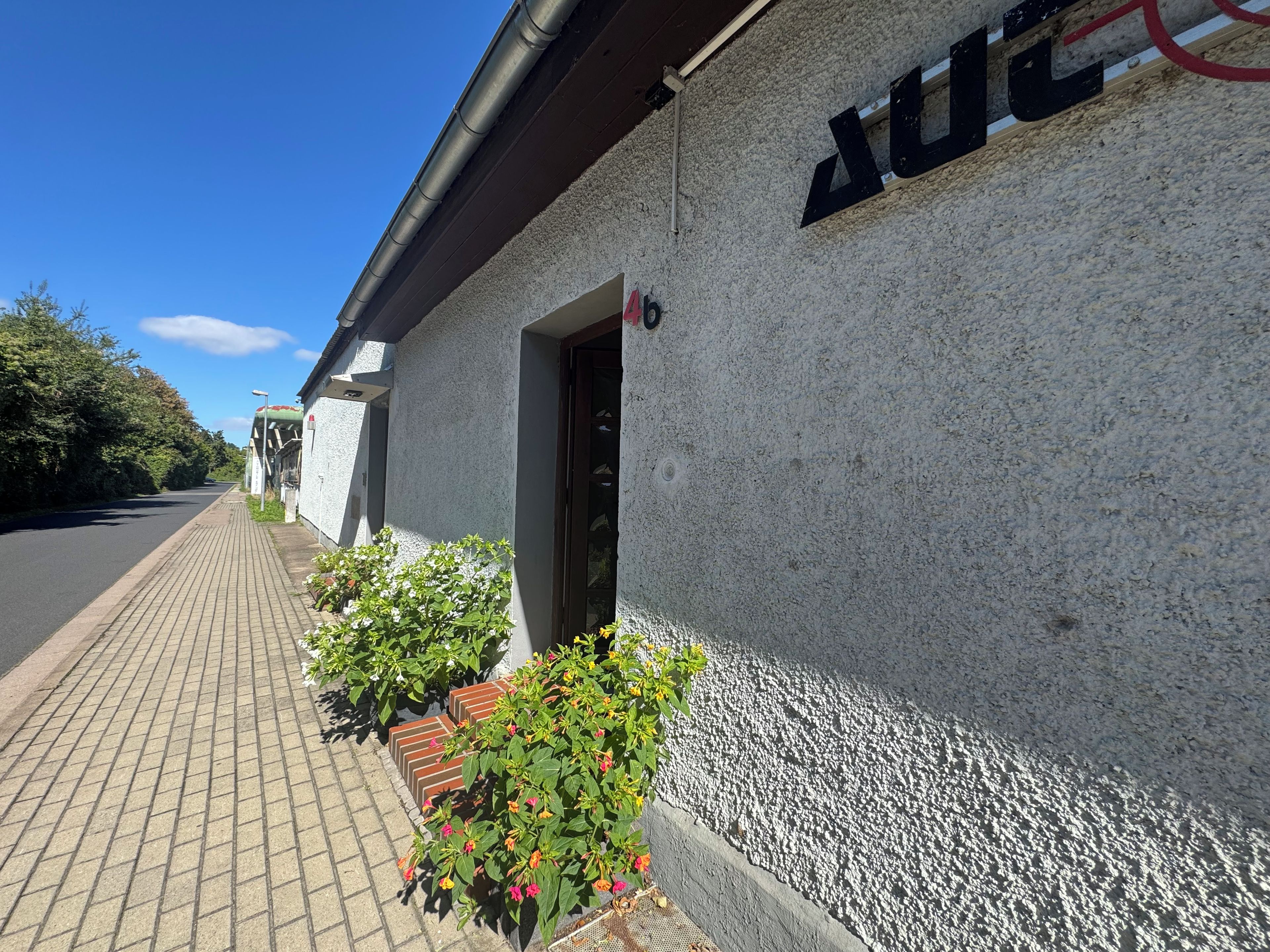 A building with a textured exterior wall and a clear sky.
