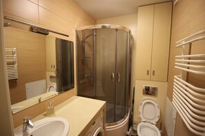 Shower, hair dryer, slippers, towels