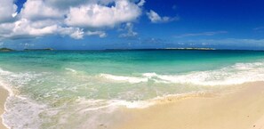 A beach with clear turquoise water, white sand, and distant islands. - Villa Cazou, vue mer, piscine privée, Wifi 100Mbps (Oyster Pond)