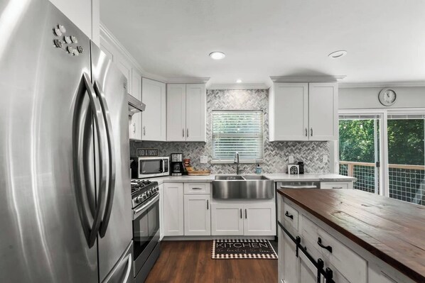 Enjoy cooking in this well-equipped kitchen with a refrigerator, oven, and ample counter space.