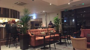 A spacious lobby with a seating area, a bar, and a stage for live music. - Luxury apartment in Whitbarrow Holiday Village near Pooley Bridge & Ullswater (Penrith)