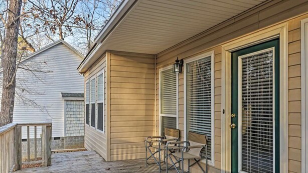 A wooden deck with a bench and a door with a window. - Lake Murray Lake Front Home W/Kayaks , close to Dreher Island (Prosperity)