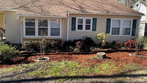 A two-story house with a brick roof, a front porch, and a landscaped yard with mulch and small plants. - Lake Murray Lake Front Home W/Kayaks , close to Dreher Island (Prosperity)