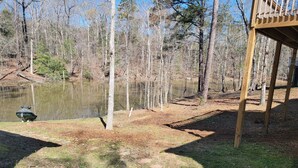 A wooden deck with a pond and trees in the background. - Lake Murray Lake Front Home W/Kayaks , close to Dreher Island (Prosperity)