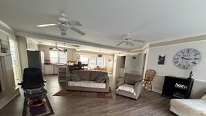 A spacious living area with a sofa, armchairs, a dining table, and a kitchen in the background. - Lake Murray Lake Front Home W/Kayaks , close to Dreher Island (Prosperity)
