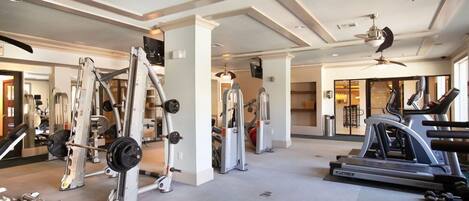 A gym with various exercise equipment, including weight machines and cardio machines.
