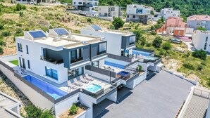 A modern two-story house with a rooftop pool, a hot tub, and solar panels. - Gorgeous home in Makarska (Makarska)