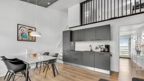 A modern kitchen with grey cabinets, a white countertop, and a stainless steel sink. - Gorgeous apartment in Ringkøbing (Ringkøbing)