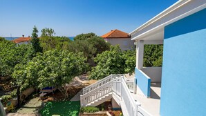 A blue building with a white staircase leading to a balcony. - 1 bedroom lovely apartment in Kosljun (Kosljun)