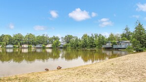 A lakeside property with several cabins and a sandy beach. - Amazing home in Oosterwolde (Oosterwolde)