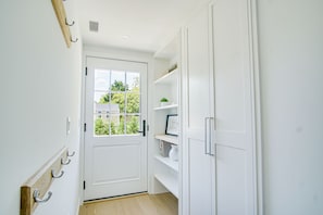 Enter a serene space with a view of lush greenery through the door.