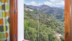 A view from a window overlooking a mountainous landscape with scattered buildings. - Amazing apartment in Genalguacil (Genalguacil)