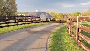 A rural road leading to a house with a wooden fence on both sides. - Quiet, Spacious House Close to SML and Liberty University (Moneta)