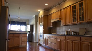 A kitchen with wooden cabinets, a refrigerator, and a countertop. - Quiet, Spacious House Close to SML and Liberty University (Moneta)