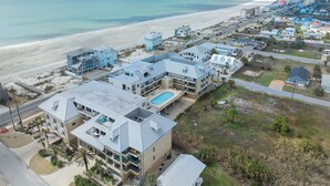 A coastal hotel with multiple buildings, a beach, and a clear view of the ocean. - Beach Paradise - Perfect Ocean Sunset Views with Pool & Sauna & Breakfast! (Mexico Beach)