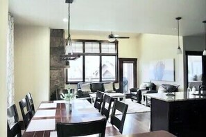 Enjoy meals in this dining area with a long table and comfortable chairs.