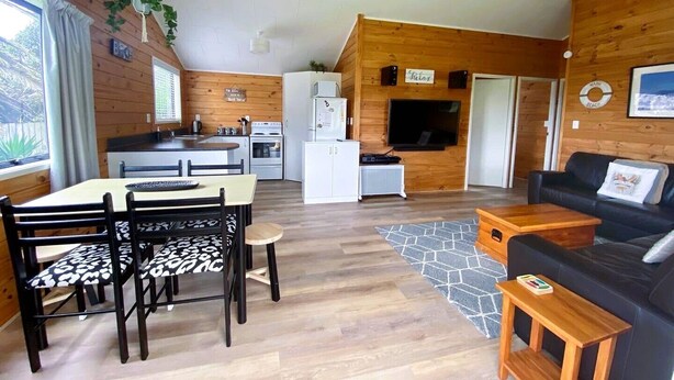 A modern, open-plan living space with a kitchen, dining area, and seating area.