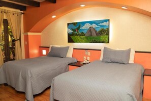 A hotel room with two beds, a painting of a pyramid, and a window with curtains. - Catedral Hotel (San Cristóbal de las Casas)