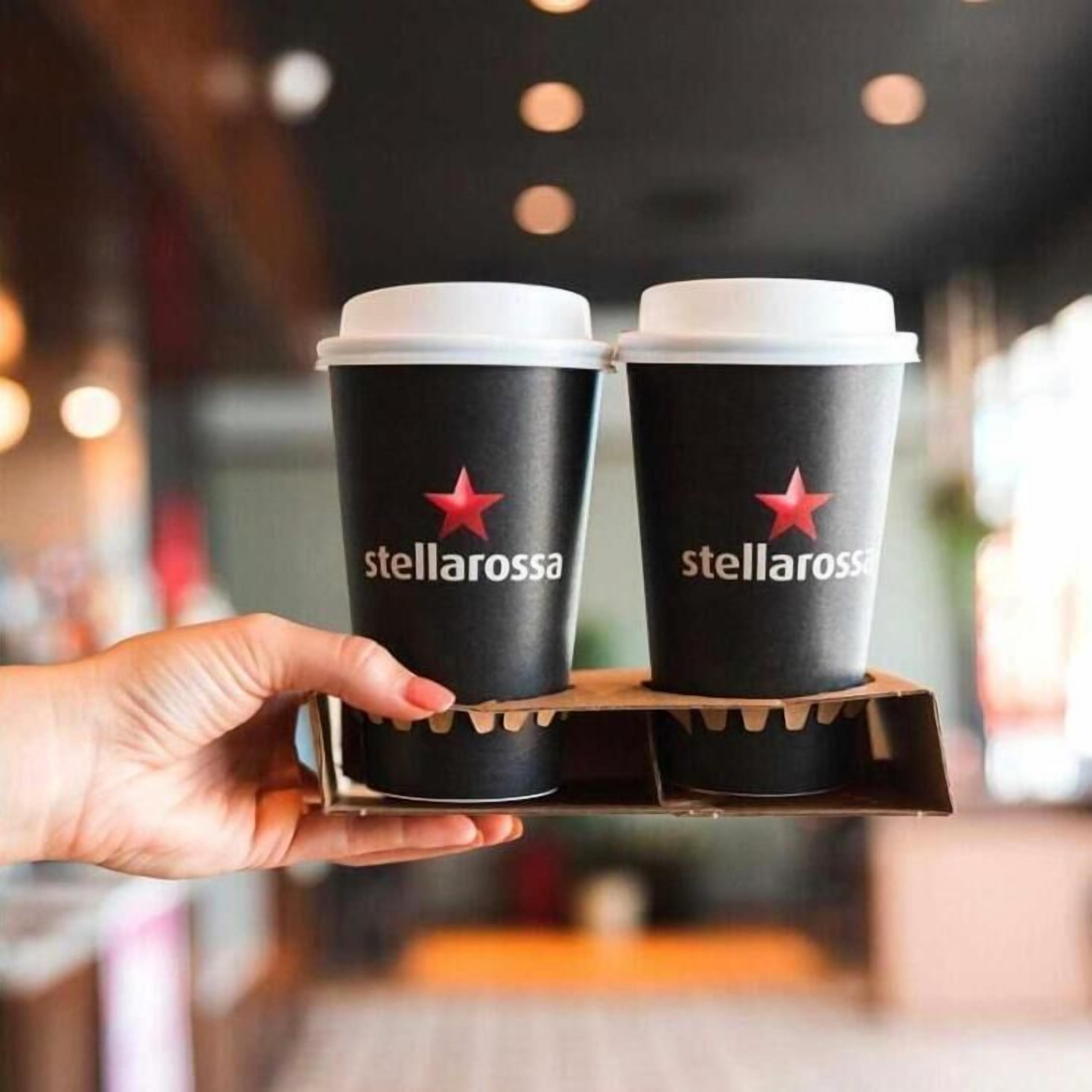 A hand holding two cups with 'stellarossa' branding and a red star logo.