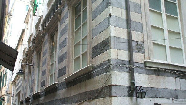 A historic building with a stone facade, large windows, and a visible entrance. - Hotel Genziana (Genoa)