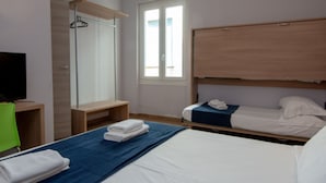 A hotel room with a large bed, a smaller bed, a desk with a TV, a wardrobe, and a window. - Hotel Genziana (Genoa)