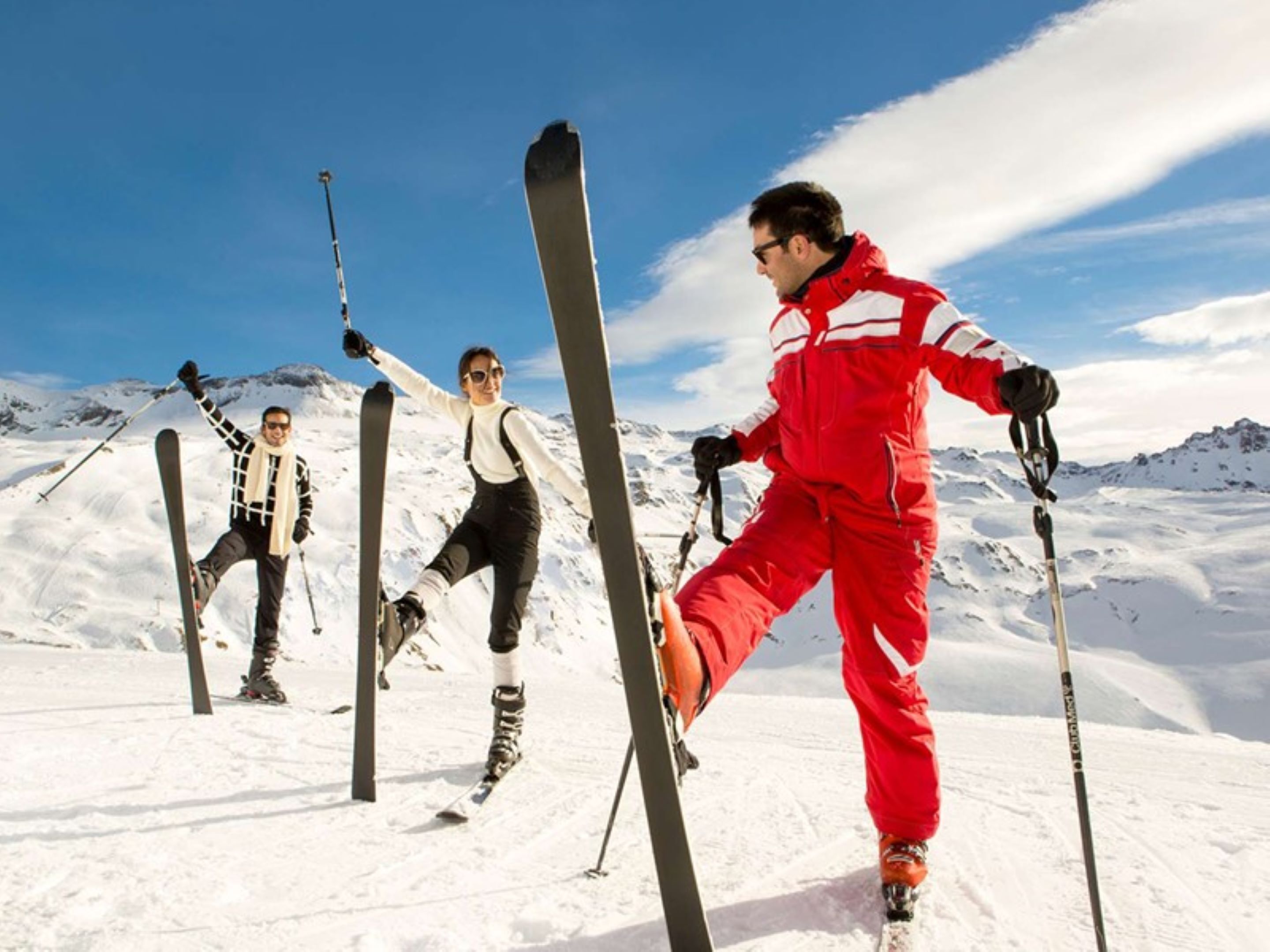 A snowy mountain landscape with skiers.