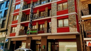A multi-story hotel with balconies, a sign for 'Andino', and cars parked in front. - Hotel Andino (Encamp)