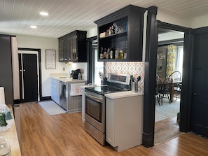 A modern kitchen with a built-in oven, a microwave, and a coffee maker.