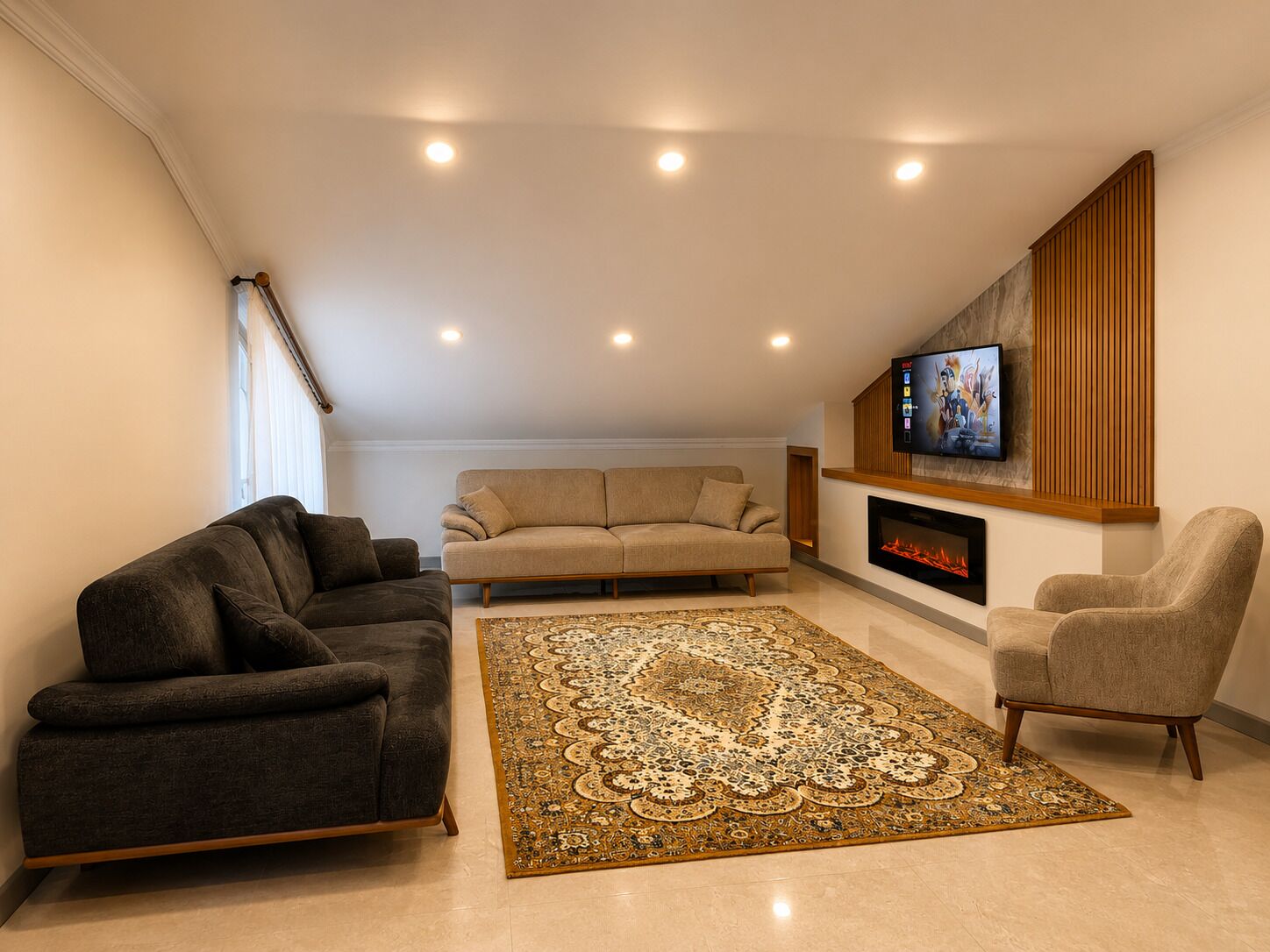 A living room with a sofa, armchairs, a patterned rug, a fireplace, and a TV mounted on the wall.