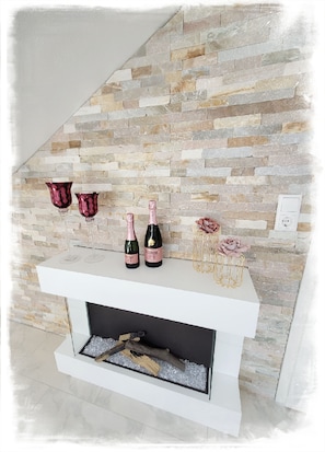 Cozy up by the fireplace with a shelf for your essentials.