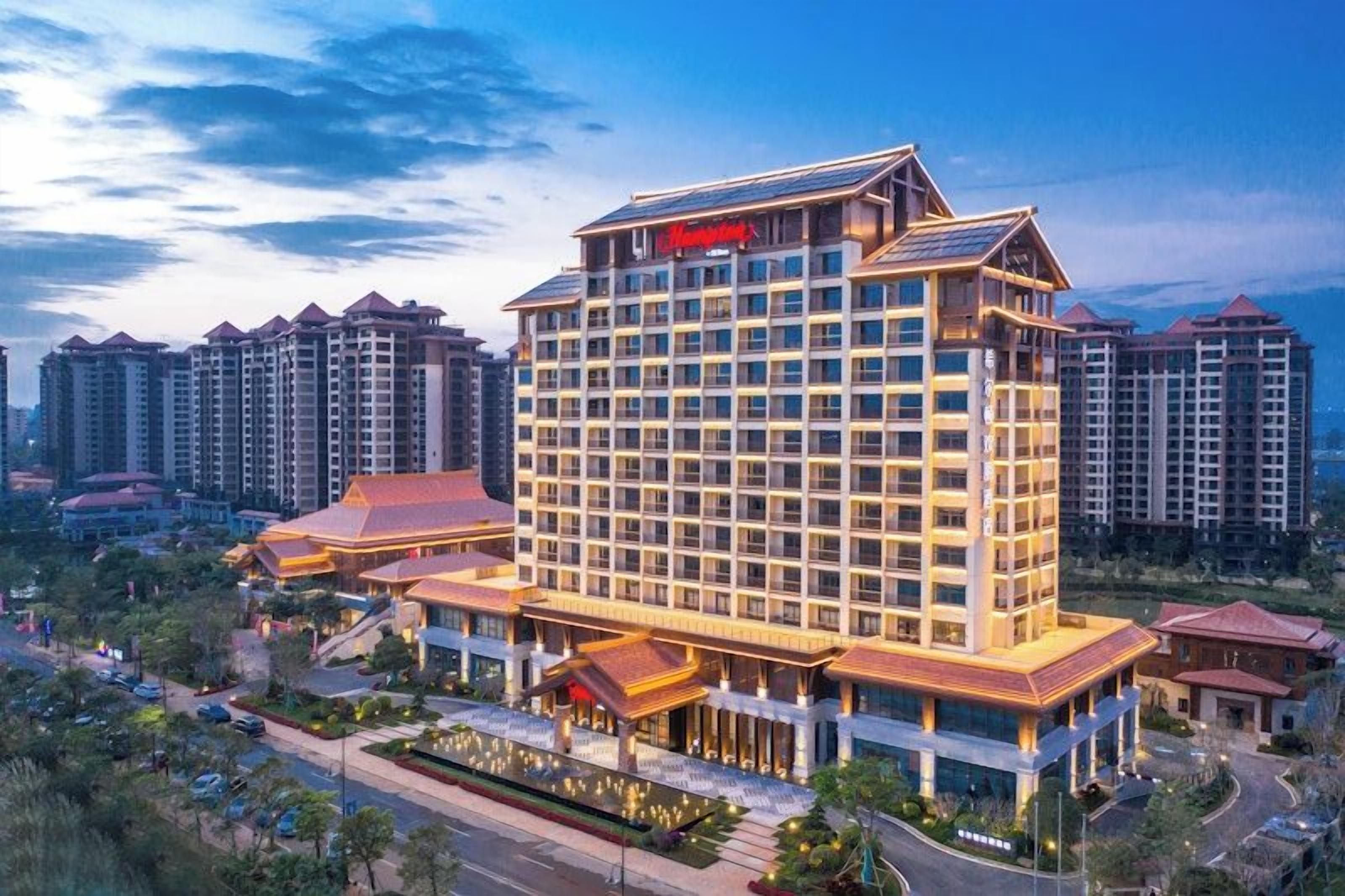 A multi-story hotel with a prominent entrance, surrounded by high-rise buildings.