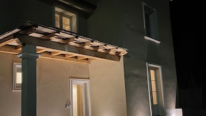 A two-story building with a covered porch, a door, and a window. - Casa Riservata Immersa Nella Natura con Spiaggia Raggiungibile a Piedi (Toscana)