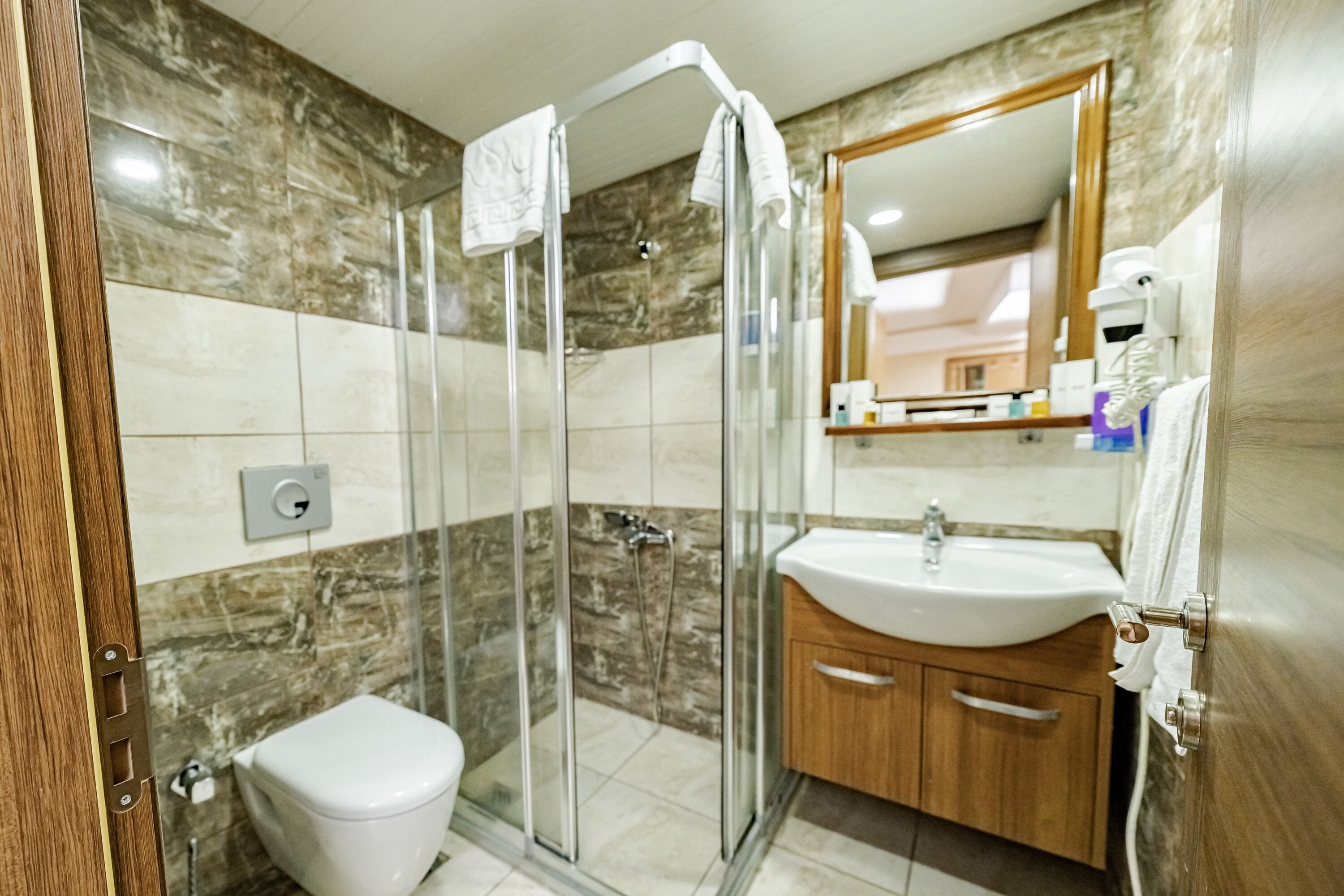 family room with city view and no balcony | bathroom | shower, free toiletries, hair dryer, slippers