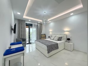 A modern bedroom with a large bed, bedside tables, a TV, and a balcony.