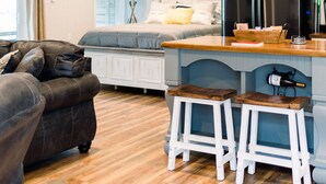 A compact living space with a kitchen area, a bed, and a seating area. - Downstairs Studio style apartment on the River (Mermentau)