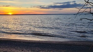 A beach with pebbles and driftwood. - Private Lake Superior Beachfront Retreat on 200 Acres (South Range)