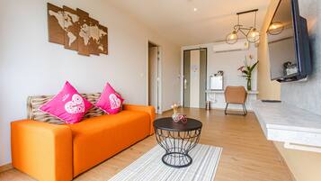 Grand Deluxe | Living area | 42-inch flat-screen TV with satellite channels, TV