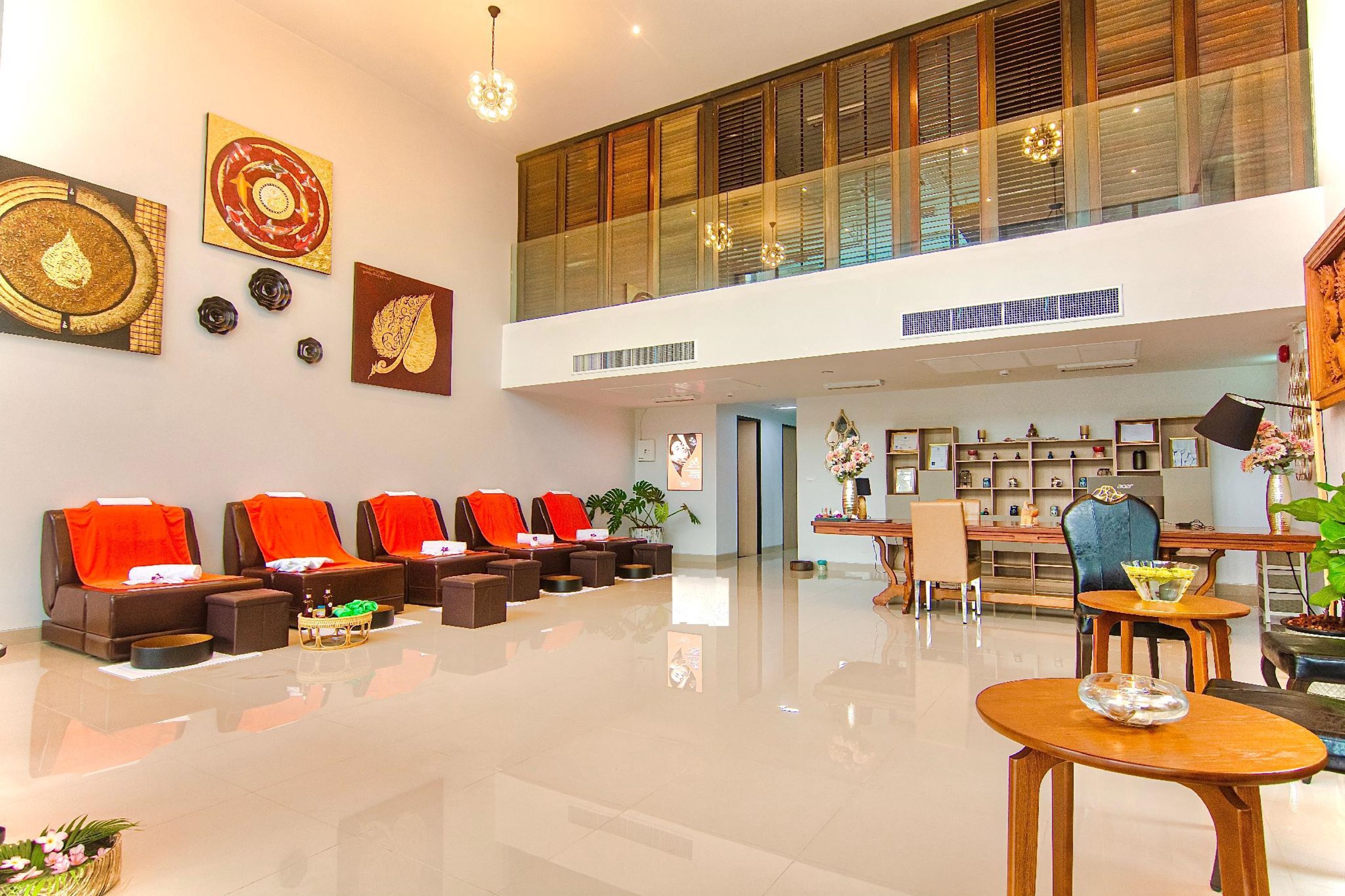 A spacious lobby with a seating area, a reception desk, and artwork on the walls.