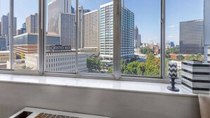 A view from a window overlooking a cityscape with modern buildings, including one labeled "CRISTO REY." - 1001 Walk to Soccer 2026, MBS, DT ATL, Parking (Atlanta)