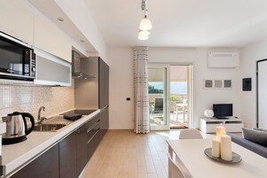 Panoramic Apartment | Living area | 30-inch TV with digital channels