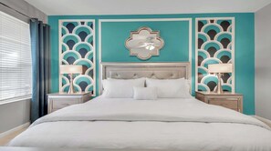 A bed with white bedding, two bedside tables with lamps, a ceiling fan, and decorative wall panels. - Disney Getaway w/ Private Pool & Spa (Kissimmee)