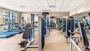 A gym with various exercise machines, treadmills, and dumbbells. - 6BR @ Storey Lake/Harry Potter & Star Wars Rooms (Kissimmee)