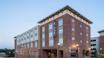 Welcome to the Hampton Inn, featuring a modern design with a brick facade and a flat roof.