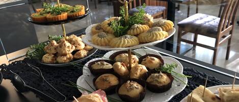 A buffet table with various pastries and desserts.